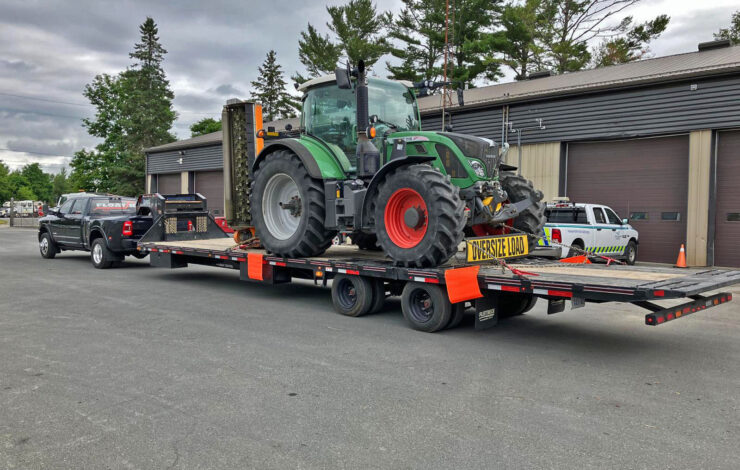 hot shot truck hauling a trailer with a tractor